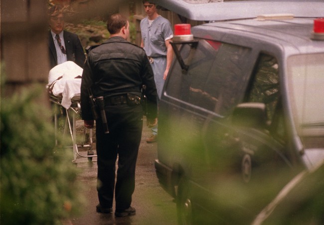 The body of Nirvana lead singer Kurt Cobain is taken to a medical examiner's van, after he was found dead earlier that day at his home in Seattle, Wash., on April 8, 1994. According to a police source, Cobain died from a self-inflicted shotgun wound, and a suicide note was found next to the body. 