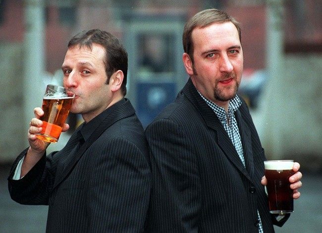 New Radio One Breakfast Show presenter Mark Radcliffe (left) acts the lad as he shares an early pint with his sidekick Marc 'Lard' Riley in Manchester this morning (Thursday). Radcliffe takes over the crucial slot following the controversial termination of Chris Evans' contract earlier this week. Date: 23/01/1997