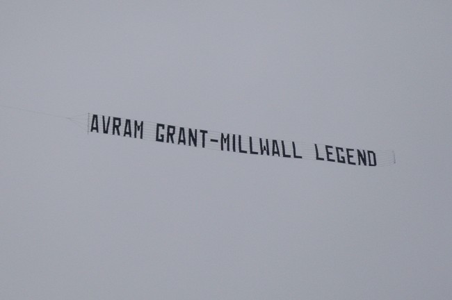 A banner mocking West Ham's manager Avram Grant is trailed by a plane as the team lose 3-2 at Wigan Athletic and are subsequently relegated in their English Premier League soccer match at The DW Stadium, Wigan, England, Sunday May 15, 2011. (AP Photo/Jon Super) NO INTERNET/MOBILE USAGE WITHOUT FOOTBALL ASSOCIATION PREMIER LEAGUE(FAPL)LICENCE. EMAIL info@football-dataco.com FOR DETAILS.