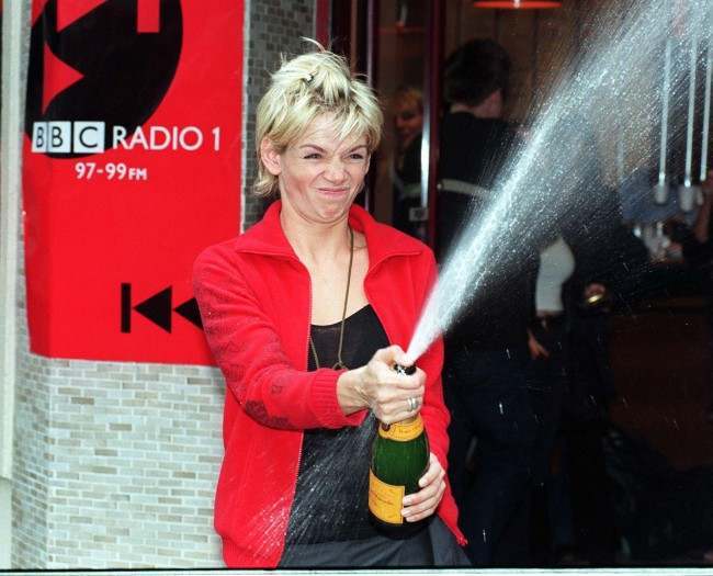 Radio 1 DJ Zoe Ball celebrates with a bottle of champagne during a photocall in London this morning (Monday) after she became the first female DJ to present the BBC Radio 1 Breakfast Show alone. Photo by Michael Stephens/PA. See PA story SHOWBIZ Zoe Date: 28/09/1998