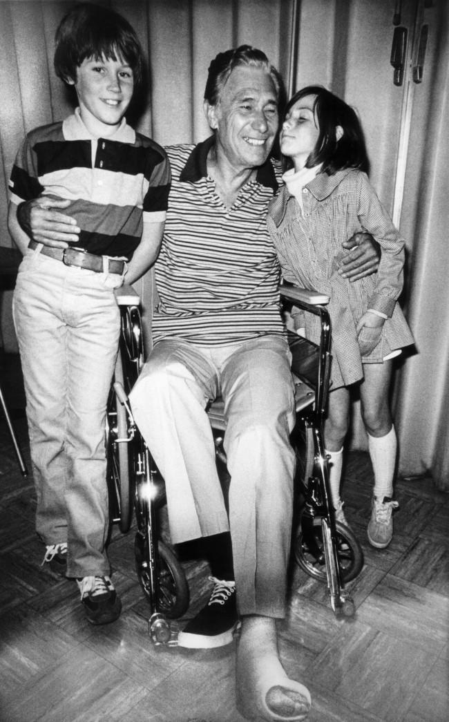 John Combs of Haleiwa, Hawaii, one of the survivors of the Pan Am-KLM crash, hugs his grandchildren after arrival at the University of California-Irvine Medical Center in Anaheim, Calif., March 31, 1977. His foot is in a cast. The children are Sean, 10, and Sabrina, 7. Combs and his wife were among survivors returned to the U.S. from the Canary Islands by military aircraft. 