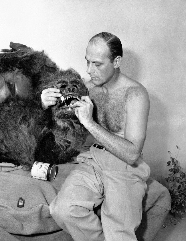 Steve Calvert applies nail polish to the teeth of the gorilla skin he wears for roles in Hollywood movies and TV shows, Nov. 7, 1955. The head is fitted with a mechanical steel frame for opening and closing its mouth. Calvert activates the frame by moving his own jaws. 