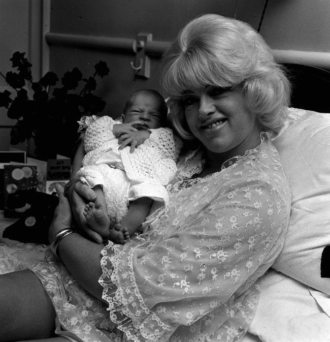 British film femme fetale, DIANA DORS, 37 holds her five-day old baby son, JASON LAKE in her bed at a Welbeck Street nursing home in London today (Monday). Diana's third husband, Alan Lake, 28 is the father of Jason. Diana has two other sons, Mark, 10, and Gary, 7. They live in Hollywood with their father Dickie Dawson. Ref #: PA.1244663  Date: 15/09/1969
