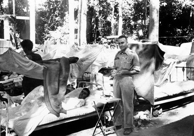 Bombing victims lie on beds with mosquito netting in an open-air army hospital in Bataan, Philippines, on April 11, 1942.