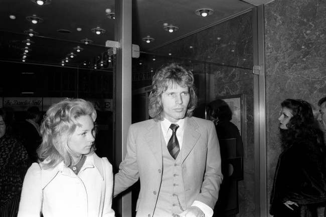 BBC Radio DJ Johnnie Walker with guest arriving at the Warner West End Theatre to attend the premiere of the film Performance starring James Fox and Mick Jagger. The woman in the picture could be wife/girlfriend Frances Kum whom he married in 1971 but needs to be confirmed