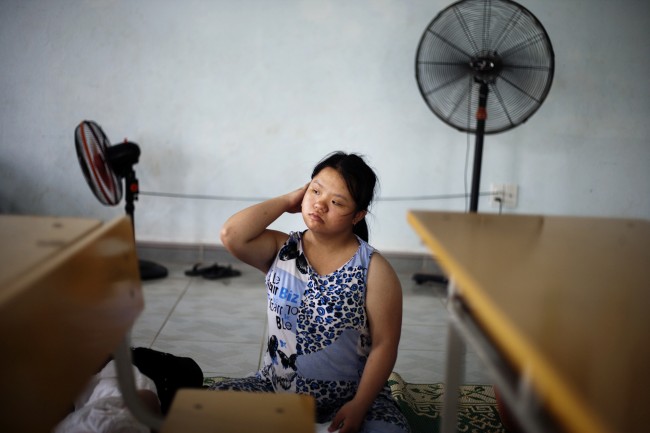 In this photo taken Tuesday Aug. 7, 2012, Le Thi Kim Lien wakes up after noon's nap at a rehabilitation center in Danang, Vietnam. The children were born with physical and mental disabilities that the center's director said were caused by their parents' exposure to the chemical dioxin in the defoliant Agent Orange. Washington was slow to respond, but on Thursday, Aug. 9, 2012 the U.S. for the first time will begin cleaning up leftover dioxin that was stored at the former military base, now part of Danang's airport.