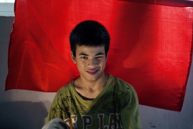 In this photo taken on Aug. 8, 2012, Dang Cong Chinh, 17, smiles at a rehabilitation center in Danang, Vietnam. 