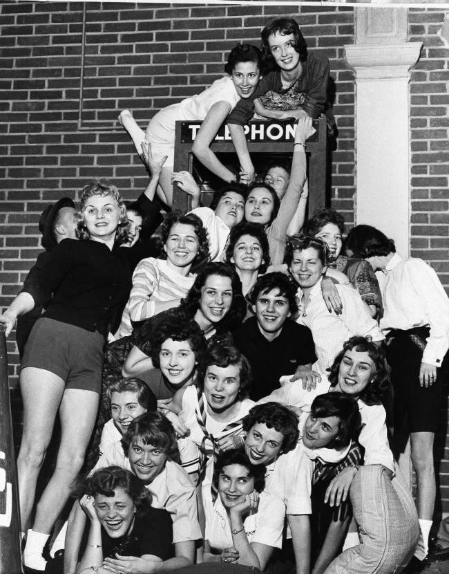 26 coeds from Memphis State University, members of the Sigma Kappa Sorority proclaimed themselves world champions, April 1,1959 to day in the art of stuffing a telephone booth at Memphis. A spokesman for the girls said since they had neither seen nor heard of prior female stuffed telephone booths they were proclaminig the championship. 