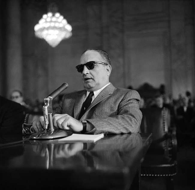 Carlos Marcello, alleged baron of the New Orleans underworld, shown as he appeared before the Senate Rackets Committee, March 23, 1959, Washington, D.C. Marcello invoked the Fifth Amendment 35 times in 15 minutes in refusing to answer questions about his occupation, sources of income and associations. 