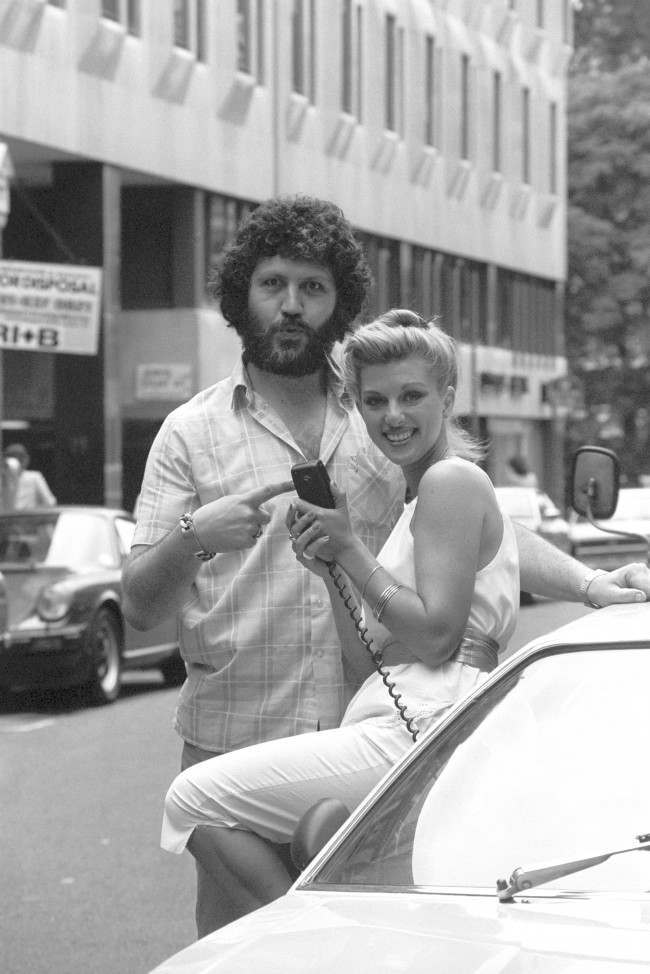 BBC Radio One DJ Dave Lee Travis poses with model Nicky Giles, 23, to promote the first CB radios in Britain, which were demonstrated by Fidelity Radio at the Eyeball Bistro Club in London. Date: 20/08/1981 