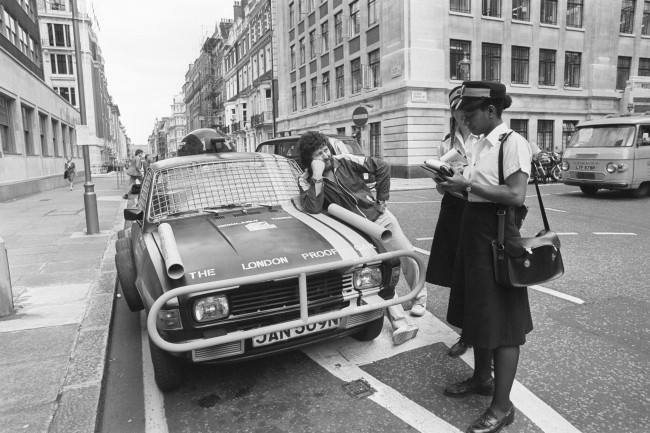 Radio DJ Dave Lee Travis has an encounter with traffic wardens as he unveils his customised 'London-proof' car. Date: 19/08/1980
