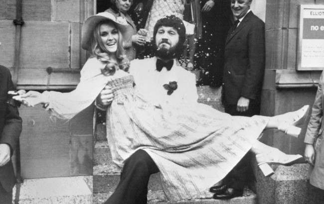 BBC DJ Dave Lee Travis carries his Swedish wife Marianne Bergqvist following their wedding at Manchester Registry Office. Date: 05/06/1971