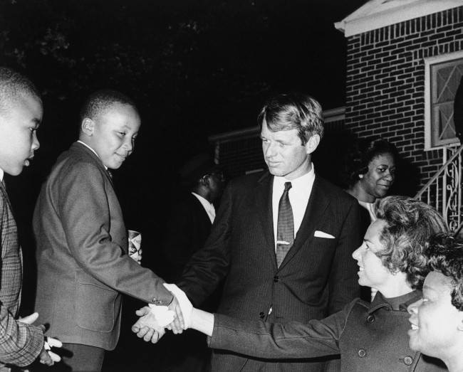 Ethel Kennedy shakes hands with Martin Luther King III after she and her husband Robert F. Kennedy, center, visited his mother Coretta Scott King at her Atlanta home, April 8, 1968. 