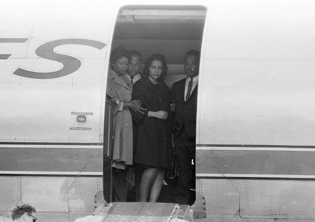 Coretta Scott King, center, widow of slain civil rights leader Dr. Martin Luther King, Jr., is comforted in the doorway of an airliner in Memphis, Tenn., April 5, 1968, as her husband's body is brought up the ramp.