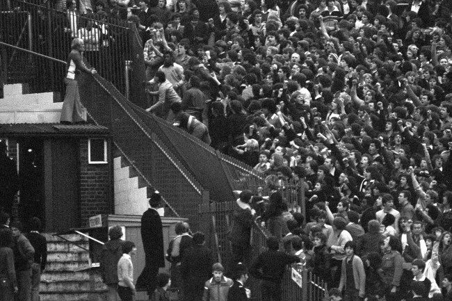 Rioting Tottenham Hotspur fans tear down a section of iron railings in a bid to reach the Chelsea supporters before a Division One game at London's Stamford Bridge ground. archive-pa186658-1   Date: 18/11/1978