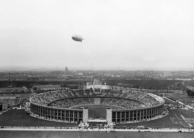 The German airship Hindenburg flies over the Olympic Stadium, outside Berlin, on August 1, 1936, during the opening ceremony of the Olympic Games.