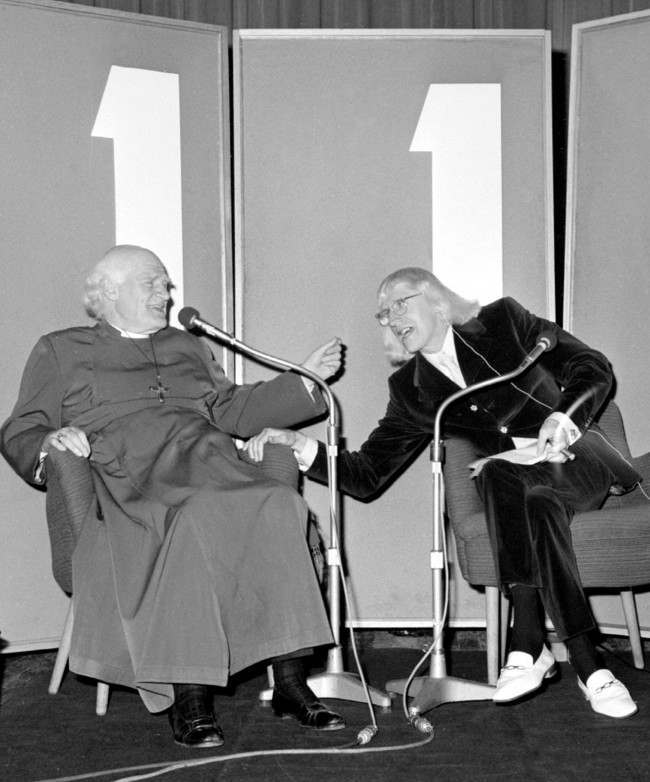 Jimmy Savile (r), host of BBC Radio One's programme "Speak Easy", looks like a bit of a laugh in. Saville's guest is Dr Michael Ramsey, Archbishop of Cantebury, shown during the recording of the programme at the BBC's Paris Theatre, Lower Regent Street, London. Date: 30/04/1971