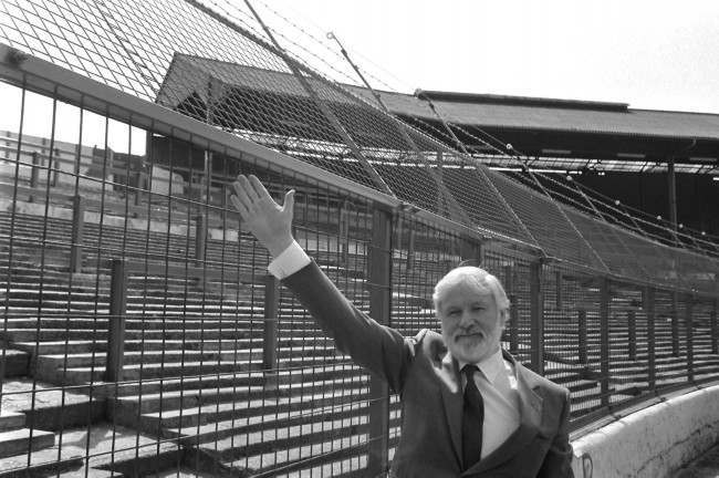 Chelsea chairman, Ken Bates, indicating the controversial anti-hooligan 12-volt electric wire on top of the 12ft high fence screening spectators from the pitch at Stamford Bridge football ground when it went on public show for the first time. NULL Ref #: PA.1896191  Date: 24/04/1985