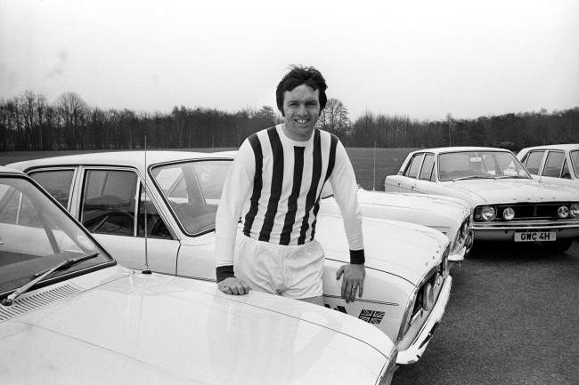 England and West Bromwich Albion's Jeff Astle, wearing his West Bromwich Albion shirt, sits on the bonnet of his new Ford Cortina