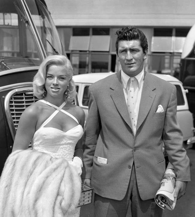 Film star Diana Dors, who has filed a divorce petition against her husband, Dennis Hamilton, pictured with actor Tommy Yeardye before they left London Airport for Rome. Ref #: PA.1945649  Date: 02/07/1957