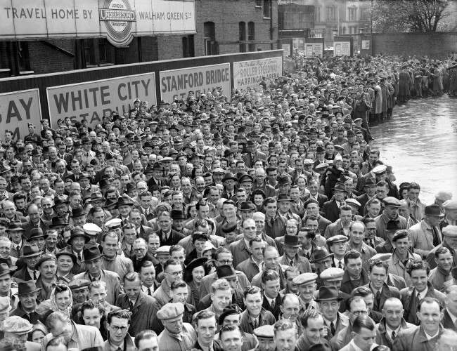 The start of the Football season. League football started for the first time in seven years, and it attracted large crowds. Here spectators are gathered outside Chelsea's Stamford Bridge ground where Bolton Wanderers are the visitors in the First Division.  Ref #: PA.1991435  