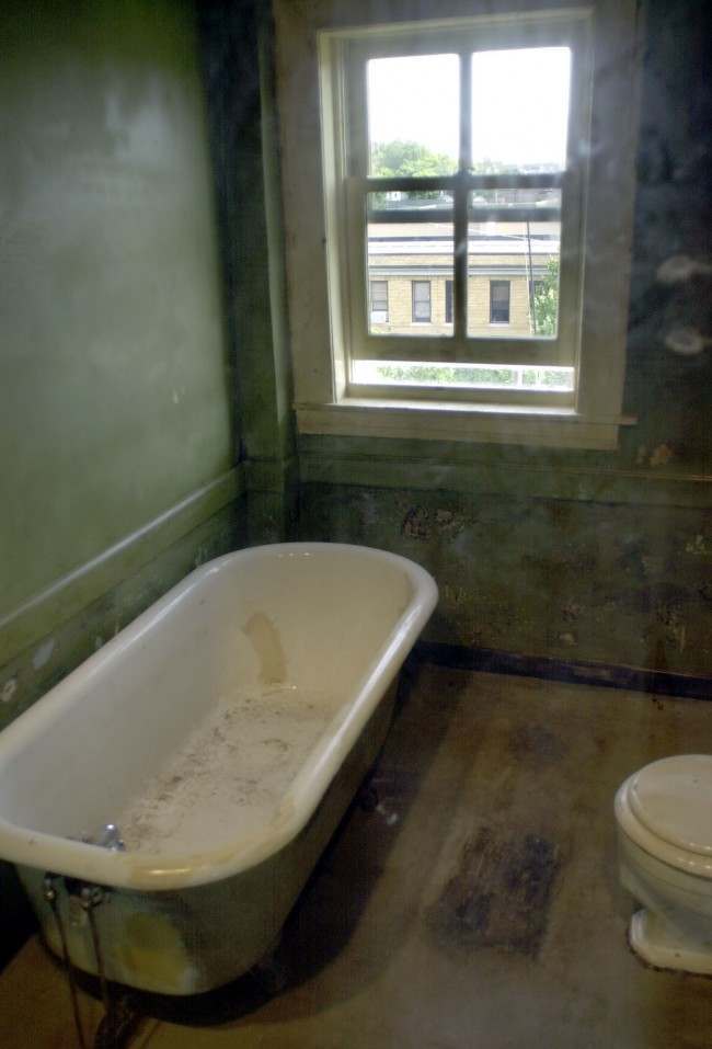 * The new $11 million expansion of the National Civil Rights Museum in Memphis, Tenn., includes the communal bathroom, seen here in this Sept. 24, 2002 file photo, where confessed assassin James Earl Ray shot Dr. Martin Luther King Jr., on April 4, 1968. Ray admitted shooting King from the small bathroom window across from the Loraine Motel in Memphis, Tenn. The bathroom is now encased in glass. The flophouse bathtub has been sold to an online casino for $7,600, the tub's owner said Thursday. 