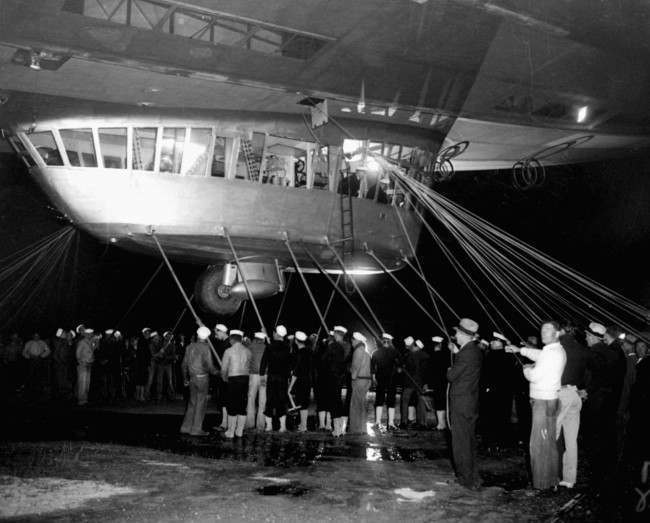 Spectators and ground crew surround the gondola of the German zeppelin Hindenburg as the lighter-than-air ship prepared to depart the U.S. Naval Station at Lakehurst, NJ,on its return trip to Germany. May 11th, 1935, 