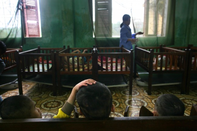 Physically and mentally disabled children sit in their room at a "peace village" center for people suspected to have been damaged by the dioxin found in the chemical defoliant Agent Orange and other illnesses, in the village of Thuy An, Vietnam on Tuesday, May 15, 2007.