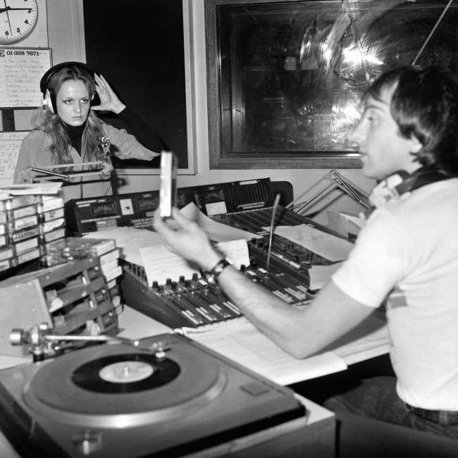 Model and singer Twiggy at the Capital Radio studios with Graham Dene, helping out on his show.