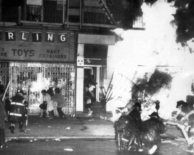 Firemen battle a blaze on 125th Street in Harlem, New York, on April 4, 1968, after a furniture store and other buildings were set on fire after it was learned that civil rights leader Dr. Martin Luther King had been assassinated in Memphis.