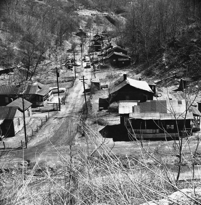 This is a community in Blue Grass Hollow not far from Hazard, Ky. March 29, 1962. It was formerly the mine camp of Blue Grass Mine which was, at one time, a big operation a big commissary, school and church. Now just the tar-paper roofed homes remain. The tipple is gone. The residents work small truck mines in the county when they can find work.