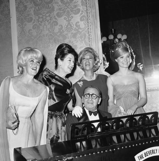 Irving Berlin is joined by Ginger Rogers, Rosalind Russell, Dinah Shore and Yvette Mimieux, left to right, as the 75-year-old composer plays his well known "Always," in Hollywood, March 5, 1963. The occasion was the big night for Berlin, staged by the Screen Producers Guild.