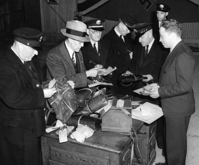Customs officers search through baggage items salvaged in the Hindenburg explosion in Lakehurst, N.J., May 6, 1937. 