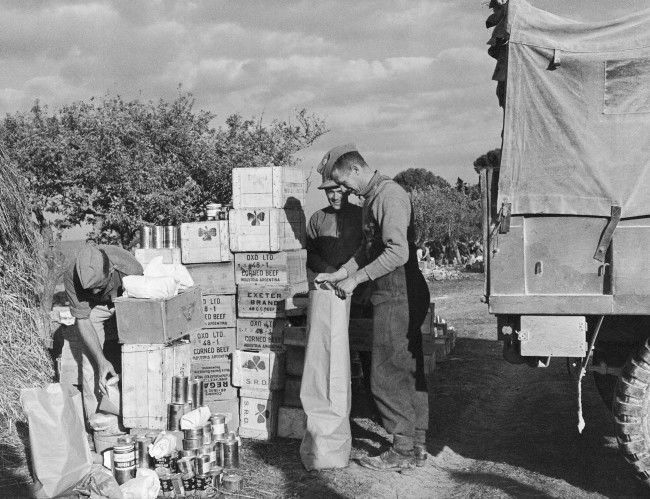 As far as the Royal Canadian Army Service Corps was concerned, the anti-malaria, synthetic quinine pill, Mepacrine, was just another item on the food list, to be rationed to units from supply points like bread and cheese and meat, Jan. 17, 1944. But as far as the Royal Canadian Army Medical Corps was concerned, Mepacrine in the Mediterranean was the difference between a strong healthy fighting forces an one which was ridden through with malaria. Men received their weekly ration of the little yellow tablets and the result among Canadians in North Africa, Sicily ad Italy was a less than 10\% malaria rate and only 0.25 deaths in every 1,000 men. Shown here is an R.C.A.S.C. supply point, with stocks of Mepacrine included among normal food items. 