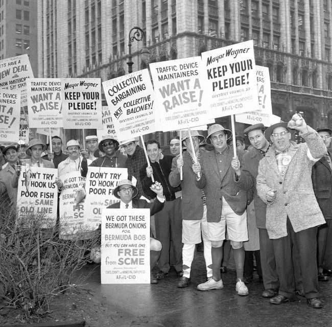 City employes protesting threats of reductions in the size of promised pay increases demonstrate at New YorkÂs City Hall Park March 31, 1959. They numbered about 2,000 police estimated. Some wore Bermuda shorts and carried fishing poles in reference to Bermuda vacation which Mayor Robert Wagner concluded the night before. Mayor blamed state government for short-changing the city and said municipal employes who left jobs to demonstrate would do so at their own expense. 