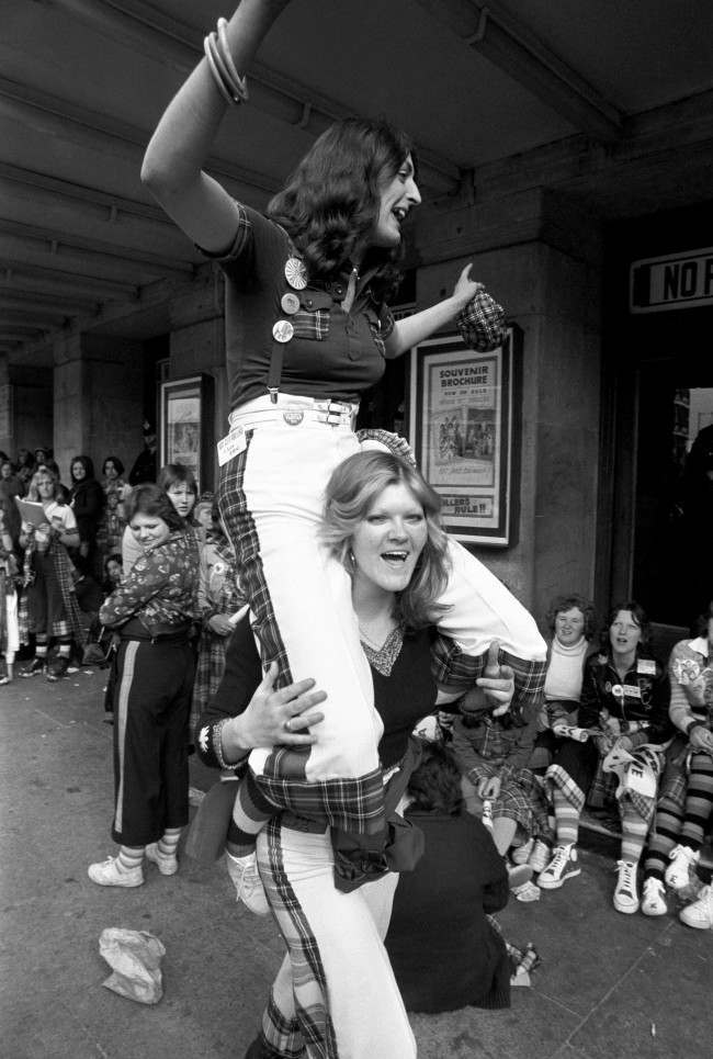 High spirits from two fans of the Bay City Rollers, as they wait with other fans for the doors to open at the Odeon, Hammersmith, for the first of two concerts by the group. PA/PA Archive/Press Association Images.