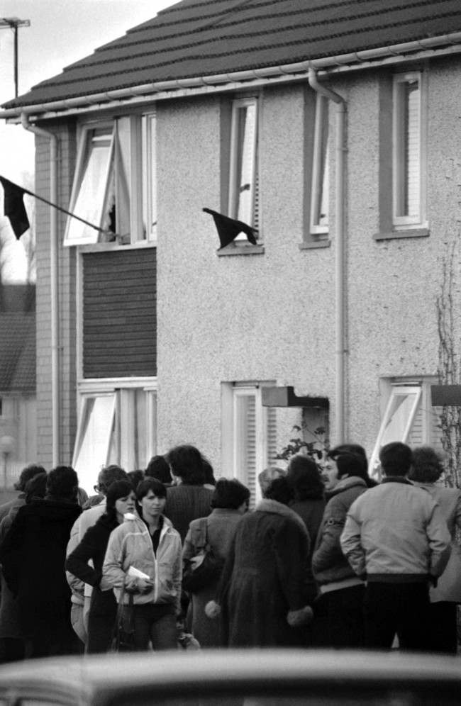 Black flags fly from the windows, as people queue outside the home of Bobby SandsÂ parents in the Twinbrooks area of Belfast, Northern Ireland on May 6, 1981, to view SandsÂ body. IRA hunger striker Sands, died in Northern Ireland's Maze Prison on Tuesday, after 66 days on hunger strike.