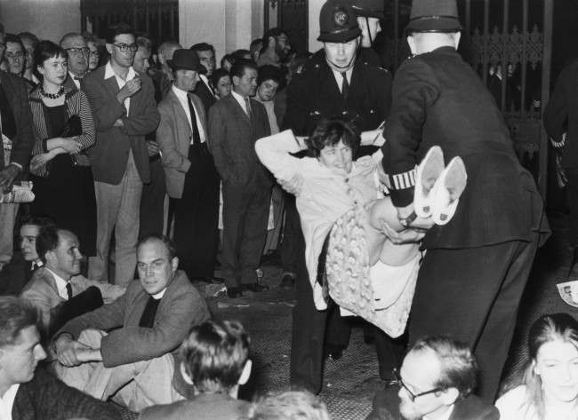 A demonstrator lets himself go limp as police officers carry him from Trafalgar Square, London, United Kingdom on Sept. 17, 1961 to a waiting van during the mass ban-the-bomb rally. 