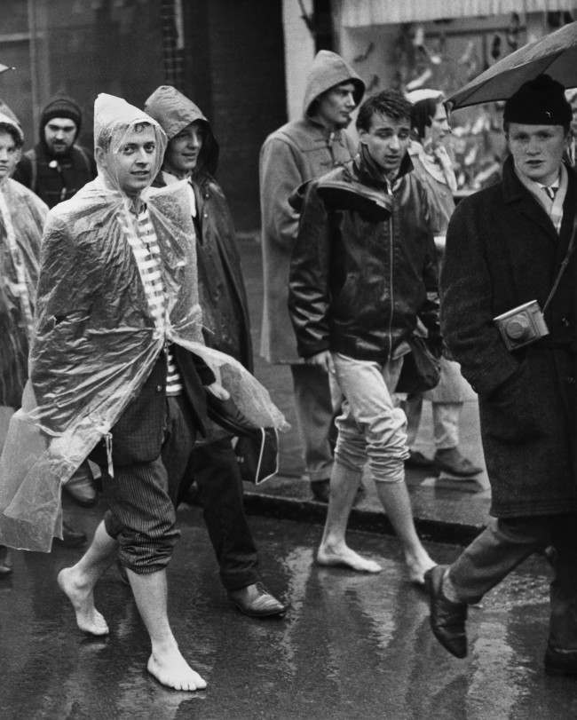 A couple of barefooted youths with trousers rolled up trudge through Cheswick, west London, in the rain on April 3, 1961, as the Aldermaston column of ÂBan-the-bombÂ marchers set off on the last weary lap of their long trek to Trafalgar Square. Another column of marchers is converging on Trafalgar Square from Wethersfield, Essex, where there is a U.S.A.F. base. They spent the night in East London.