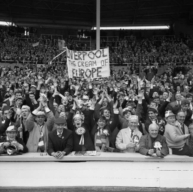 Liverpool fans show their support for their team who went on to win the match 2-1. Flag reads 'Liverpool the cream of Europe'.