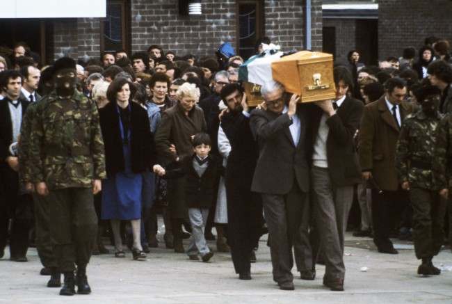 Escorted by hooded members of the Irish Republican Army, the coffin of hunger striker Bobby Sands leaves a church in Belfast, Northern Ireland on May 7, 1981, followed by his sister Marcella and his 7-year-old son Gerald.