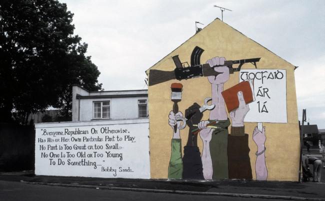 A mural painted on the side of a house in Londonderry shows a CatholicÂs perspective of the tension in Northern Ireland in 1984. The poem by the late hunger striker Bobby Sands written next to the painting states that Âno one is too old or young to do something.Â (AP Photo/Peter Kemp) Ref #: PA.11809603  Date: 01/01/1984 