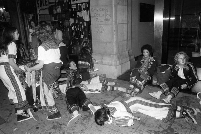 Young fans cool off outside the New Victoria Theatre in London, where teenagers went wild during a concert by the Bay City Rollers. At least 210 hysterical fans were treated for minor cuts and bruises, after flattening the first three rows of seats. PA/PA Archive/Press Association Images