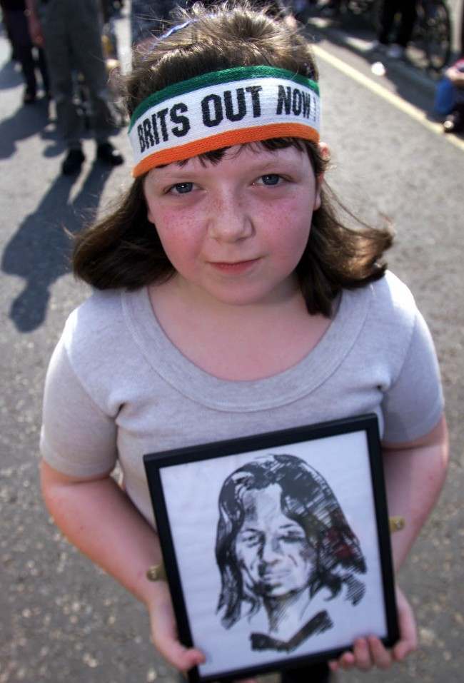 Siobhan Quinn aged 12 from Belfast wearing a" Brits out Now " headband and carrying a drawing of Bobby Sands the first IRA hunger striker to die, at the19th Anniversary of the IRA Hunger strike. Gerry Adams addressed thousands of republicans later at Dunville park. *.. on the Falls road.  Ref #: PA.1296463  Date: 07/05/2000 