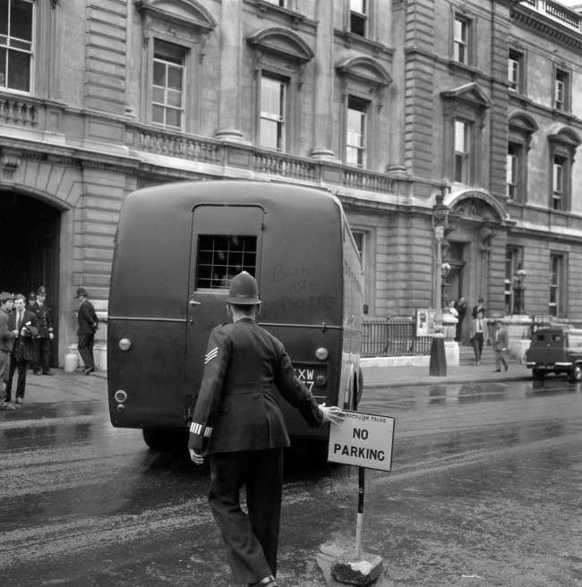 "Ban-the-Bomb" is written inn the dust on the back of the Metropolitan Police Black maria van, believed to be carrying members of the the anti-nuclear Committee of 100 after they had received jail sentences at Bow Street Magistrates court. Ref #: PA.13424974  Date: 12/09/1961
