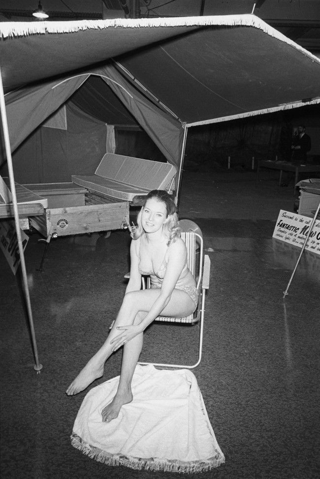 Wendy Pattenden, 26, of Bournemouth, demonstrates a tent trailer at Colex ' 70, the 12th annual Camping and Outdoor Life and Travel Exhibition which opened at Olympia, London. The trailer is made by Concraft Trailers of Roundhill, Tusmore in Bicester, Oxfordshire. Archive-pa143437-1 Ref #: PA.16531914  Date: 31/12/1969 