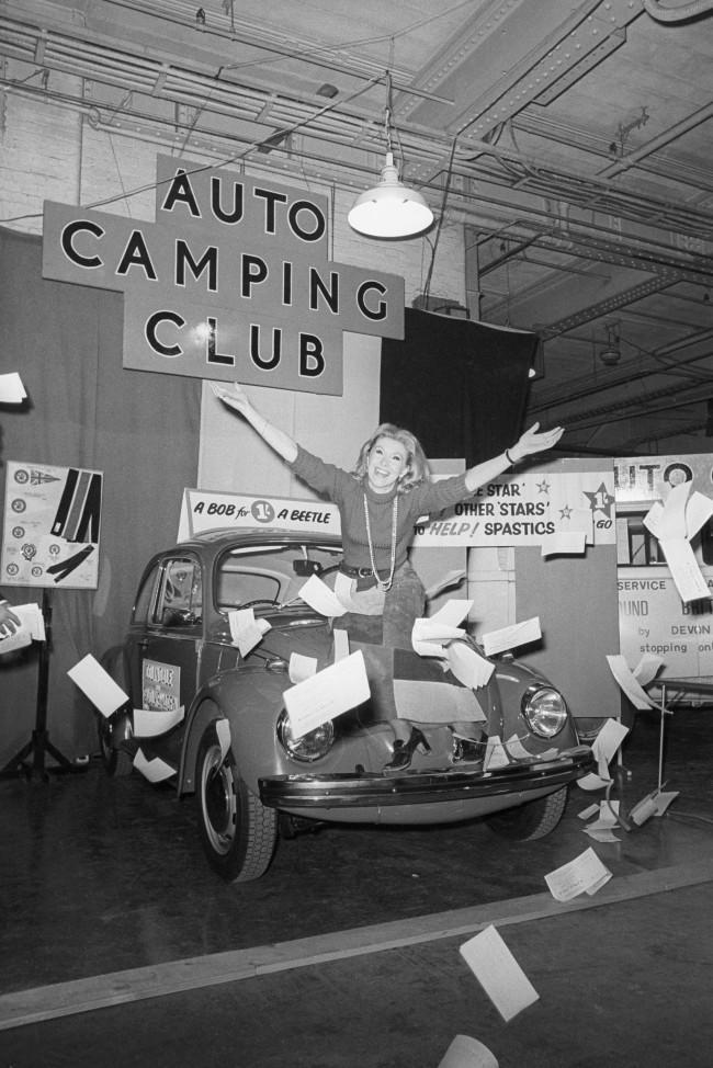 Actress Susan Hampshire in a flurry of raffle tickets at Colex ' 70, the 12th annual Camping and Outdoor Life and Travel Exhibition which opened at Olympia, London. Susan is seated on the bonnet of the new Volkswagon Beetle, which is first prize in a raffle organised by the Eastern Centre of the Volkswagon Owner's Club in conjunction with the Stars Organisation for Spastics. The raffle tickets were sold by the actress. Archive-pa143437-2 Ref #: PA.16531927  Date: 31/12/1969