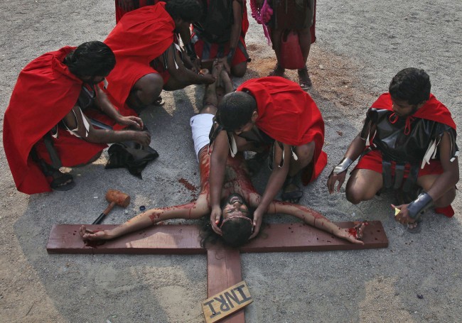An Indian Christian devotee enacts the crucifixion of Jesus Christ to mark Good Friday at The Mount Carmel Church in Hyderabad, India, Friday, April 18, 2014.