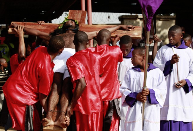 A man reenacts the death of Jesus Christ during a Good Friday performance in Abuja, Nigeria Friday, April 18, 2014. 