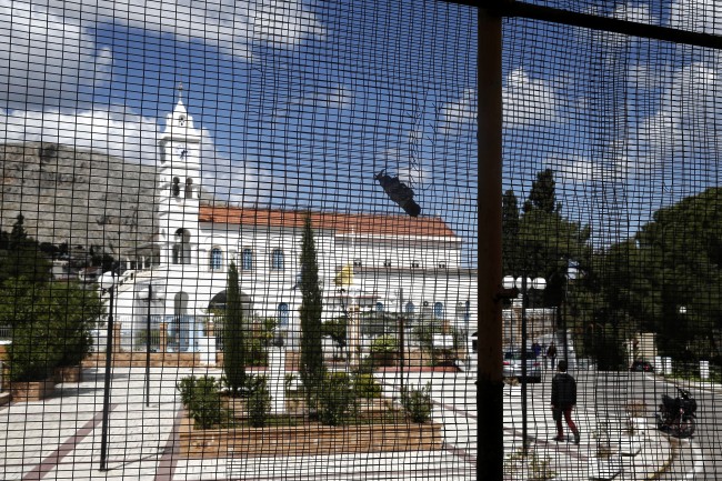  a wire fence protects a house situated near the church of Panagia Erithiani